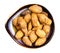 Cracked almond drupes in ceramic bowl isolated