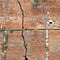 Cracked brick wall - Deep crack in a brick wall