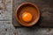 Cracked chicken egg on a wooden table