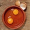 Cracked chicken eggs on a wooden table