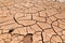 Cracked clay soil in front of the Flaming Mountains in China, Xinjiang province. Located in the Turpan depression