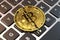 Cracked or damaged bitcoin is laying on keyboard. Paying ransom with bitcoin concept. 3D rendering
