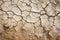 Cracked dry clay soil texture or background. Effects of climate change, desertification and droughts