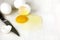 Cracked egg with egg shell, egg yolk and egg white on white background