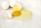 Cracked egg with egg shell, egg yolk and egg white on white background