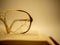 Cracked eyeglasses resting on a open book vintage look