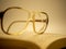 Cracked eyeglasses resting on a open book vintage look