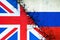 Cracked flags of Russia and England. International political relations. Conflict. Political Economic background.