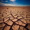 Cracked mud sand in a desert flood plain against a blue sky background mud cracks.