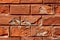 Cracked old dilapidated broken painted red brick suburban family house wall texture