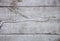 Cracked old wooden background, shabby painted wood texture, light grey rugged board, natural old rustic floor element close up top