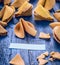 Cracked open fortune cookie with blank space on blue wooden background