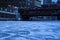 Cracked and snow covered ice in a low-angle view of a frozen Chicago River on a blue and frigid morning