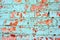 Cracked soft turquoise paint, plaster surface on red brick wall, grunge horizontal shabby background detail