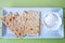 Crackers and cheese spread on green wood from above and close up