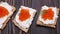 Crackers with cream cheese and red caviar close-up