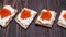 Crackers with cream cheese and red caviar close-up