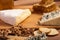 Crackers, white cheese and honey on wooden background