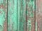 Crackled paint on old light green wood planks