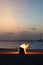 Crackling bonfire burning brightly on a picturesque beach surrounded by a calm ocean.