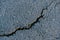 Cracks in asphalt texture, background