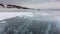 Cracks and columns of frozen methane are visible on the ice lake