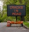 Cracks in road warning sign on trailer due to volcano