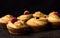 Craffin - Buns from yeast dough. Dark background. Mystical light. cinnamon craffin cinnabon mix of croissant and muffin