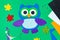 Craft, applique of an owl from multi-colored felt. Creative classes with children. Sewing soft toys, hobby.