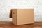 Craft blank cardboard package box presented on wooden table