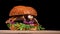 Craft burger is cooking on black background. Consist: sauce, arugula, tomato, onion, bacon, currant sauce, ricotta