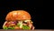 Craft burger is cooking on black background. Consist: sauce, lettuce, tomato, red onion, cucumber, cheese, bacon, air