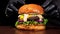 Craft burger is cooking on black background. Consist: sauce salsa, lettuce, red onion, pickle, cheese, chilli green