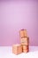 Craft cardboard gift boxes on the solid pink background. Holiday