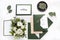 Craft green wedding envelopes with invitations on white