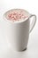 Craft latte coffee with berries powder on top in white ceramic mug. White background. Best for commercial. Content for coffee addi