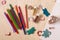 Craft station with colour pencils, bottles of beads, felt butterflies and leaf, drawing pad and wooden stamps with different motif