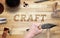 Craft word carved in wood with hammer and chisel.