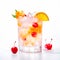 Crafted cocktail with berries, a slice of orange, ice cubes and a sprig of mint