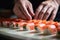 Crafting tradition: a skilled chef\\\'s hands meticulously prepare sushi rolls, a symbol of Japanese cuisine