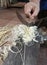 Craftman preparing bamboo for basketry work