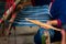 Crafts and craftsmanship. Traditional Isan Thai Cotton indigo weaving. Woman hand weaving Cotton Indigo in traditional way at