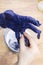 Craftsman adjusts size of finger in felted glove