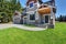 Craftsman American house with rocks trim, garage and concrete floor porch