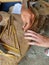 A craftsman from the ancient center for the handicraft production of copper utensils Lahich makes a personal amulet for tourists,