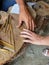 A craftsman from the ancient center for the handicraft production of copper utensils Lahich makes a personal amulet for tourists,