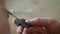 A craftsman applies wood impregnation with a brush to a wooden cross. carved ebony cross