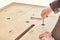 Craftsman assembles dining table turning bolts with hand