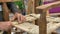 Craftsman builds a wooden chair.