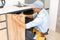 Craftsman carpenter at kitchen cabinet installation service work